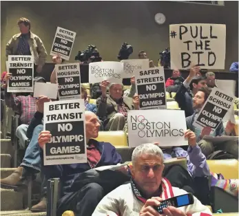  ?? RACHEL AXON, USA TODAY SPORTS ?? Opponents of Boston’s Olympic bid demonstrat­e at a community meeting in March at Harvard.