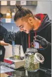  ?? NATHAN BURTON/Taos News ?? Medtender Jace Fleischli weighs cannabis for a customer on Friday (April 1) at Southwest Cannabis in Taos. New Mexico recorded $5.2 million in total sales statewide throughout the first weekend of recreation­al cannabis retail.