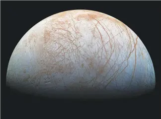  ?? NASA / JPL-CALTECH / SETI INSTITUTE VIA THE NEW YORK TIMES ?? The surface of Jupiter’s icy moon Europa is seen in a color view, made from images taken by NASA’S Galileo spacecraft in the late 1990s. The Europa Clipper mission will sail past Europa on some 40 to 45 f lybys sometime in the 2020s. Craters appear o...