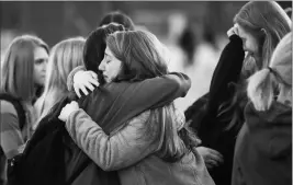  ?? RYAN HERMENS/THE PADUCAH SUN VIA AP ?? STUDENTS EMBRACE FOLLOWING A PRAYER VIGIL at Paducah Tilghman High School in Paducah, Ky., on Wednesday in Paducah, Ky. The gathering was held for the victims of the Marshall County High School shooting on Tuesday.