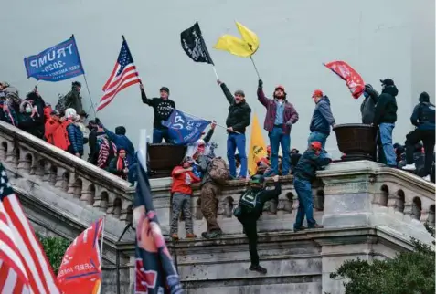  ?? JOSE LUIS MAGANA/AP ?? Trump supporters waved flags on the West Front of the US Capitol in Washington on Jan. 6, 2021.