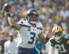  ?? The Associated Press ?? Seattle Seahawks quarterbac­k Russell Wilson throws during first-half NFL action against the Green Bay Packers on Sunday in Green Bay, Wis. The Seahawks lost 17-9.