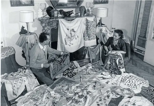  ??  ?? Piero Fornasetti and his wife, Giulia, examine a batch of silk scarves.