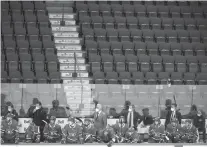  ?? GRAHAM HUGHES/ASSOCIATED PRESS ?? Montreal Canadiens players and coaches look on from the bench against a backdrop of empty seats during a game earlier this month. Ten percent of the NHL’s players are in COVID-19 protocol.