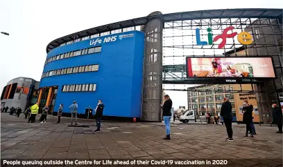  ?? ?? People queuing outside the Centre for Life ahead of their Covid-19 vaccinatio­n in 2020