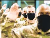  ?? Noah Berger Associated Press ?? AIRMEN take an oath as they transition to becoming members of the U.S. Space Force at a February ceremony at Travis Air Force Base near Fairfield, Calif.