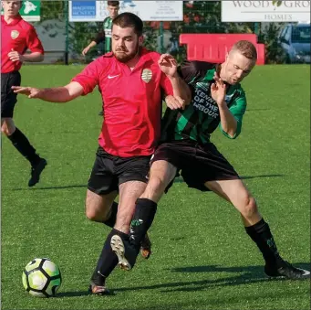  ??  ?? Macdara Kelly of Greystones United is chased by Jonny Quinn of Arklow United.