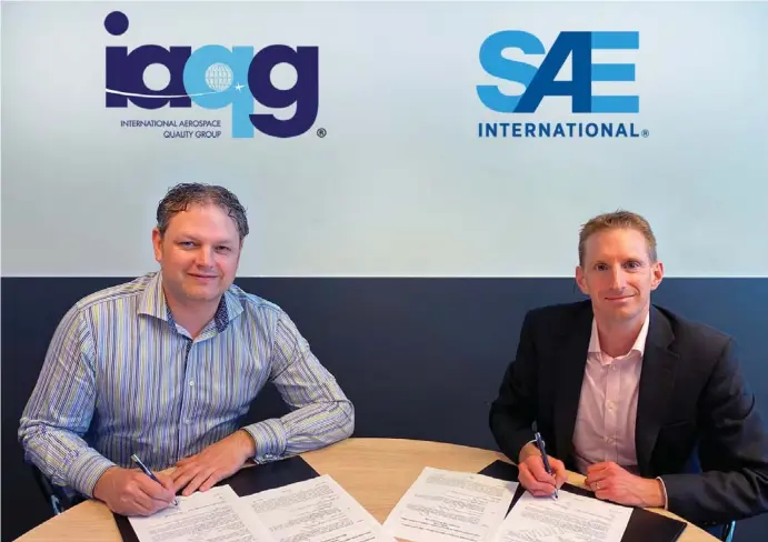  ?? ?? IAQG President, Andy Maher, BAE Systems signs the global standards publisher agreement with David Alexander, Mobility Standards Leader, SAE Internatio­nal. Image: MediaOutre­ach