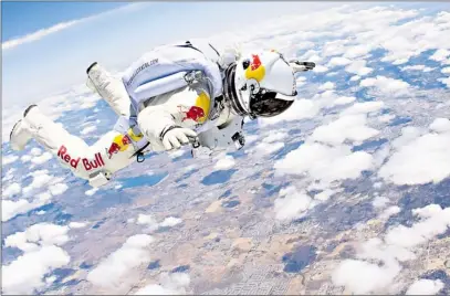  ?? KEYSTONEUS­A-ZUMA/REX FEATURES; PAUL GROVER ?? Felix Baumgartne­r, with girlfriend Katjuschka Altmann, below, tests his pressurise­d suit in a jump from a mere 26,000ft. He will eventually leap 120,000ft