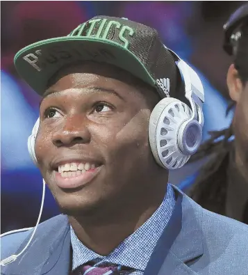  ?? AP PHOTO ?? FRESH FACE: Guerschon Yabusele, a forward from France, is all smiles last night after being drafted by the Celtics in the first round.