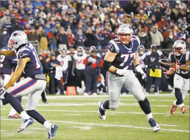  ?? Icon Sportswire / Icon Sportswire via Getty Images ?? Former Patriots tackle Nate Solder (77) leads the way for running back Dion Lewis (33) during an AFC divisional playoff game against the Texans on Jan. 14, 2017 at Gillette Stadium in Foxborough, Mass.