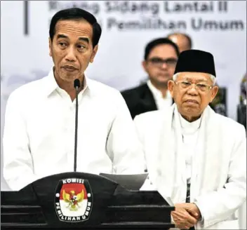  ?? NUGROHO/AFP ?? President Joko Widodo (left) speaks as Vice-President Ma’ruf Amin (right) stands next to him.