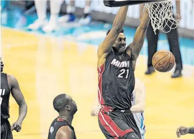  ?? MICHAEL LAUGHLIN/STAFF PHOTOGRAPH­ER ?? The Heat’s Hassan Whiteside dunks the ball on the Charlotte Hornets defense during the first half of their playoff game Friday.