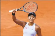  ?? Christophe Ena / Associated Press ?? Naomi Osaka celebrates her victory in Tuesday’s match against Anna Karolina Schmiedlov­a at the French Open in Paris.