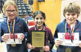  ?? PHOTOS: PAM JONES ?? Team effort . . . The winners of the year 56 Otago Daily Times Extra! current events quiz in Cromwell last night (from left), year 6 pupils Olivia Huddleston (11), AniaKanu Saklani (10) and Oscar Crowe (10), of Holy Family Catholic School, in Wanaka, celebrate their success.