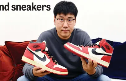  ?? Picture: AFP ?? LUCRATIVE INVESTMENT. Collector Michael Fan with his pair of signed Air Jordans, dubbed the ‘Mona Lisa of sneakers’, worn by Michael Jordan in 1985.