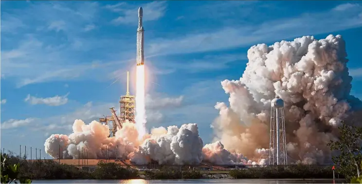  ?? — Reuters ?? Up, up and away: A SpaceX Falcon Heavy rocket lifts off from historic launch pad 39-A at the Kennedy Space Center in Cape Canaveral, Florida.