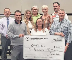  ?? ?? Driver Julie Vandivort, center, was presented with a check by members of the Community Foundation of the Ozarks–Mountain Grove Area Community Foundation.