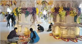  ?? Picture: AP Photo/Rajesh Kumar Singh ?? Workers decorate a temple dedicated to Hindu deity Lord Ram with flowers the day before the temple’s grand opening in Ayodhya, India.