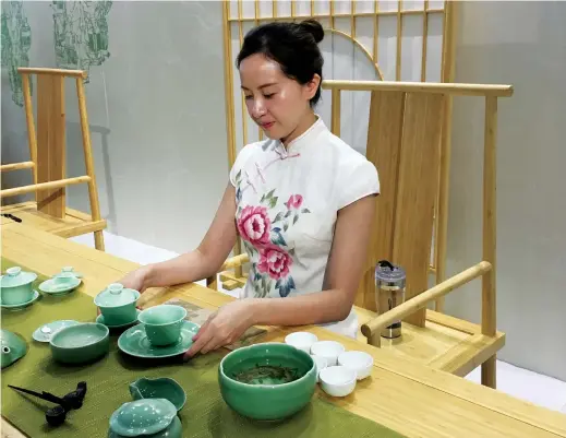  ??  ?? A tea ceremony is performed by a staff member from China National Tea Museum at the 12th Hangzhou Cultural and Creative Industry Expo. The expo has become one of the four largest cultural and creative trade shows in China.