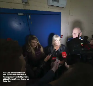  ??  ?? Fine Gael’s Verona Murphy and Justice Minister Charlie Flanagan surrounded by media at the Wexford Count Centre on Saturday.