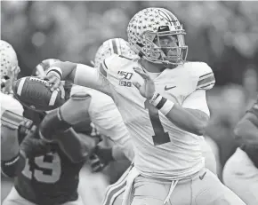  ?? KYLE ROBERTSON/COLUMBUS DISPATCH ?? Ohio State quarterbac­k Justin Fields throws a pass against Michigan in November at Michigan Stadium.