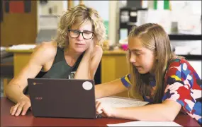  ?? Chris Palermo / For Hearst Connecticu­t Media ?? Rosie Strickland shows off her schoolwork to her mother Amy Strickland at Roton Middle School in Norwalk.