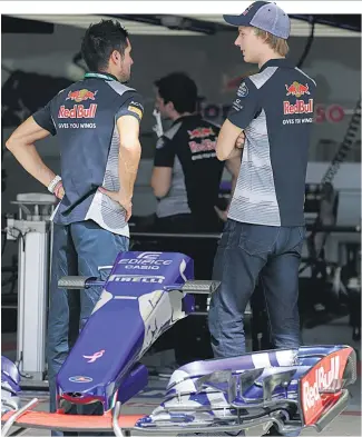  ?? Picture / AP ?? Kiwi Brendon Hartley ( right) in the pits as Toro Rosso crew work on his car for the US Grand Prix.