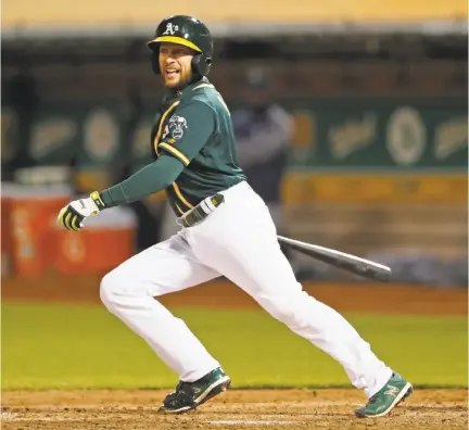  ?? Photos by Scott Strazzante / The Chronicle ?? Jed Lowrie (top) watches his RBI double that drove in Matt Chapman in the sixth. Lowrie and Chapman combined to drive in six runs and score four.