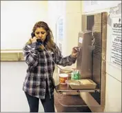  ?? Kent Nishimura Los Angeles Times ?? ADRIANA ESPEJEL tries to call the Mexican consulate while being held at an ICE processing center.