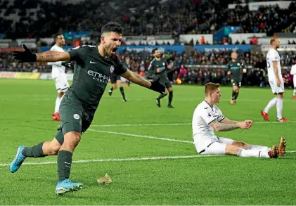  ?? PHOTO: GETTY IMAGES ?? Sergio Aguero celebrates scoring for Manchester City in their 4-0 rout of Swansea City in the Premier League.