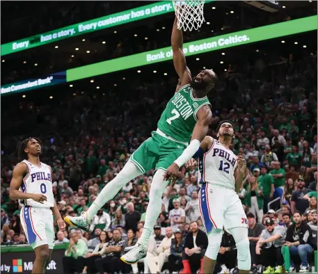  ?? (NANCY LANE/BOSTON HERALD) MAY 14, 202 ?? Boston Celtics guard Jaylen Brown goes to the basket over Philadelph­ia 76ers forward Tobias Harris during the fourth quarter of the Eastern Conference semifinals at the TD Garden on Sunday, in Boston, MA