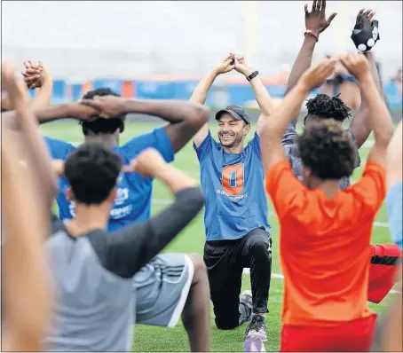  ?? [JONATHAN QUILTER/DISPATCH] ?? Olentangy Orange coach Adam Walters leads his team through warm-ups. Though many of his athletes will never be stars, they say they still enjoy being part of the team.