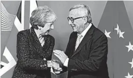  ?? EMMANUEL DUNAND/GETTY-AFP ?? EU’s President Jean-Claude Juncker greets Britain’s Theresa May, who must now sell a Brexit deal to Parliament.