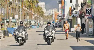  ?? Al Seib Los Angeles Times ?? SINCE the last recession, the U.S. has become more dependent on low-income jobs with poor benefits. Above, officers patrol L.A.’s Venice Boardwalk, where many businesses are closed, putting employees out of work.