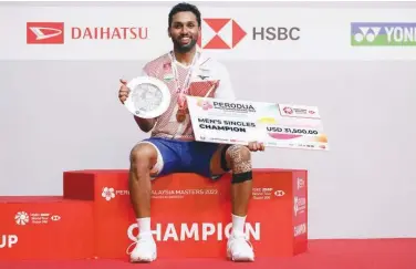  ?? Associated Press ?? ↑
India’s HS Prannoy poses on the podium after winning the men’s singles finals match against China’s Weng Hong Yang at the Malaysia Masters.