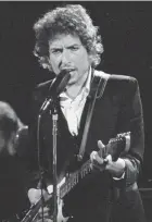  ?? JEFF ROBBINS/AP ?? Musician Bob Dylan performs with The Band at the Forum in Los Angeles on Feb. 15, 1974.