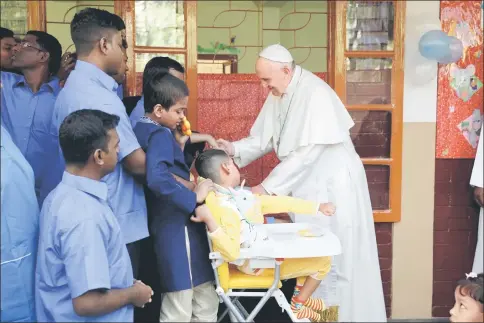  ??  ?? Francis meets with staff members and sick people at the Mother Teresa House clinic in Dhaka’s Tejgaon neighbourh­ood. — AFP photo