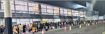  ?? ?? travel chaos: Early-morning queues outside the terminal building where passengers waited yesterday