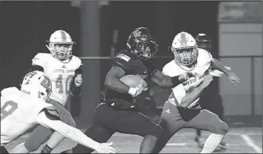  ?? Kate Fields/Special to News-Times ?? Tailwind Turner: Smackover's Greg Turner busts through Danville's defense for a big gain. The Buckaroos advanced in the 3A state football playoffs with a 49-35 win over the Little Johns Friday at Memorial Stadium.