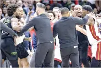  ?? PHOTO BY MATTHEW HINTON/AP ?? ALTERCATIO­N
New Orleans Pelicans forward Naji Marshall (left) and Miami Heat forward Jimmy Butler (right) are separated during a scuffle in the second half of an NBA basketball game in New Orleans, Friday, Feb. 23, 2024. Marshall and Butler were later ejected.