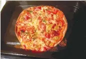  ?? — AFP ?? This undated photo released by Bill English from his Facebook page on April 7 shows pizza he made topped with tinned spaghetti and pineapple for his family in Wellington.