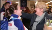  ??  ?? Laura Muir hugs her mum, Alison, after arriving at Glasgow Airport last night