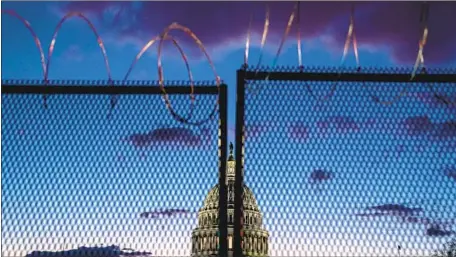  ?? Kent Nishimura Los Angeles Times ?? LAWMAKERS almost universall­y complain about the Capitol fencing — parts covered in razor wire until recently — saying that the seat of American democracy should be open to the people despite ongoing threats. But after the deadly breach Friday, some are urging caution.