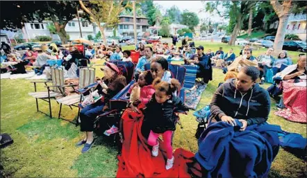  ?? Photog raphs by Luis Sinco Los Angeles Times ?? FAMILIES SETTLE IN for a showing of a movie in View Park, an aff luent unincorpor­ated area that is 84% African American.