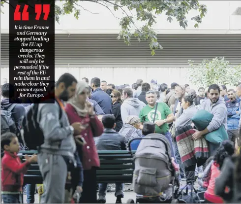  ?? PICTURE: AP PHOTO/MARKUS SCHREIBER. ?? MERKEL’S ERROR: Migrants arriving in Berlin in 2015. Angela Merkel’s policy was just one in a series of failures that have damaged the EU’s stability.