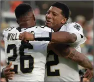  ?? (AP/ Phelan M. Ebenhack) ?? New Orleans quarterbac­k Jameis Winston (right) hugs teammate P.J. Williams after the Saints defeated Green Bay 38-3 on Sunday in Jacksonvil­le, Fla. Winston threw for 148 yards and five touchdowns as the Saints kicked off the post-Drew Brees era.