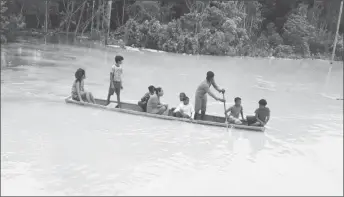  ??  ?? Residents of Three Friends navigate the community in a canoe. (Photo credit: Travis Farose).