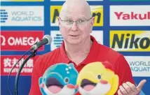  ?? Eugene Hoshiko/Associated Press ?? U.S. coach Bob Bowman speaks during a news conference at the World Swimming Championsh­ips in Fukuoka, Japan.