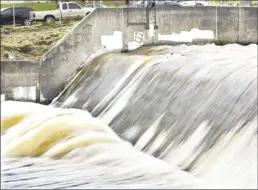  ?? ?? Wailuku River rushes through the flood control channel in Happy Valley Wednesday morning.